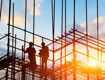 construction worker on construction site at sunset