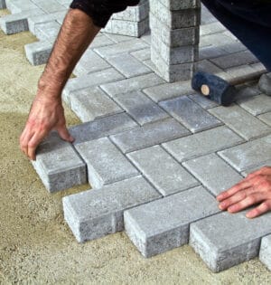 Construction of pavement. Worker puts paving