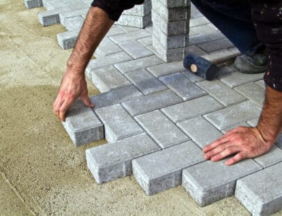 Stenmontör Construction of pavement. Worker puts paving