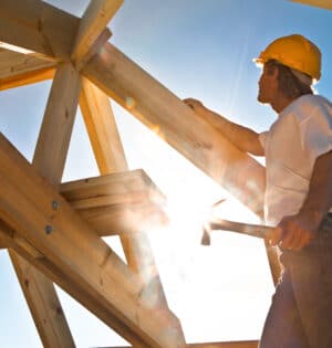 worker checking roof construction strong sun flare