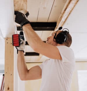 Man working and renovating a house. Mid age man doing some building.