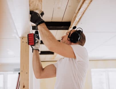 Man working and renovating a house. Mid age man doing some building.